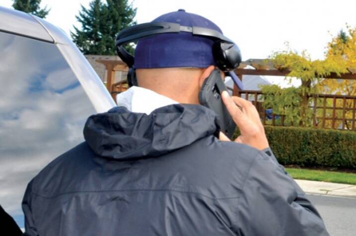 Male police officer talking on cellphone.